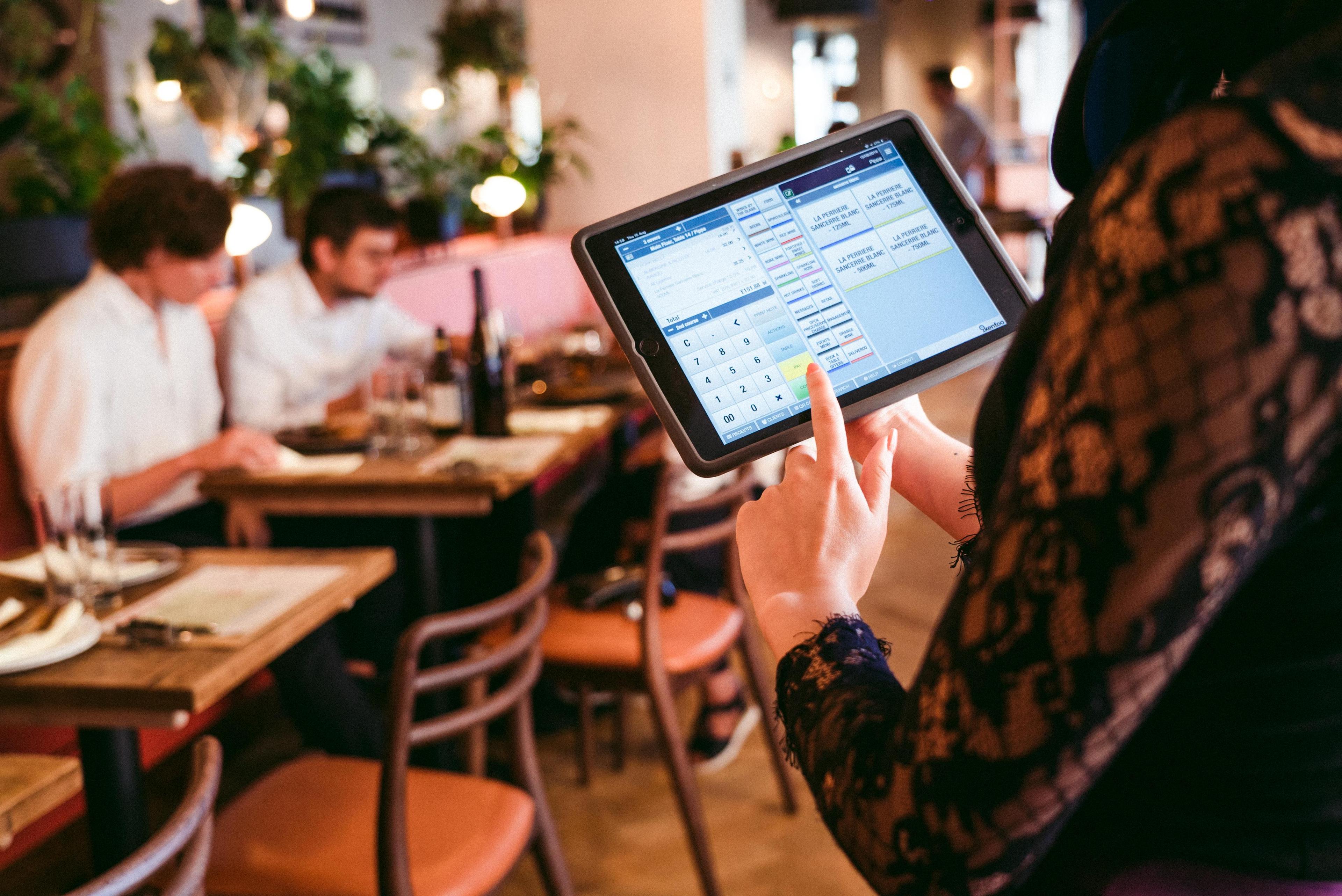Waitress using tablet to take order